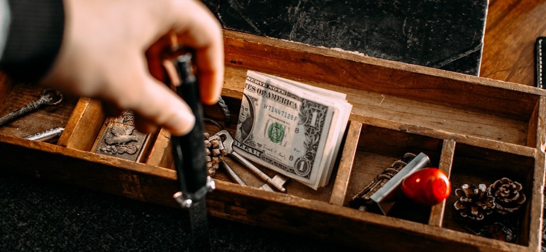 a person holding a knife in a wooden box